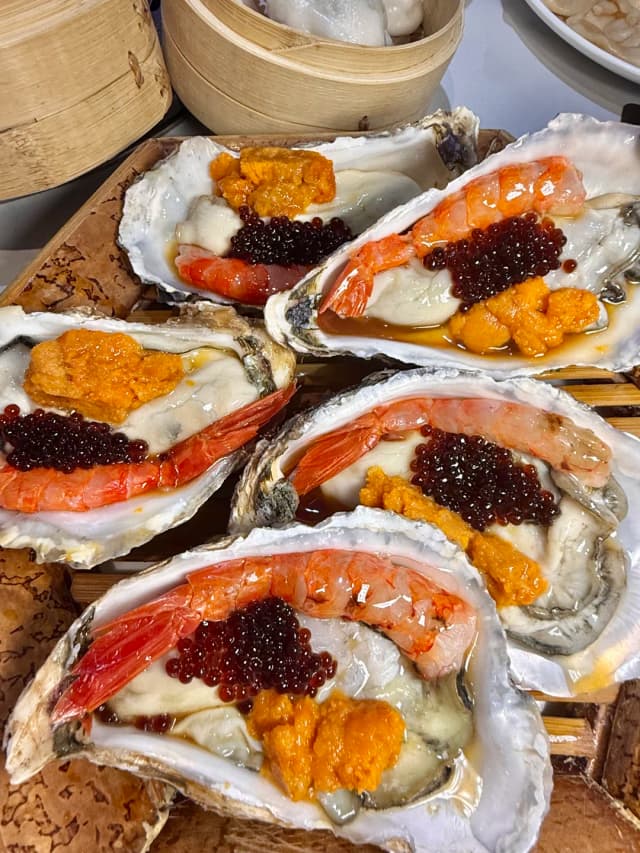 This platter of sea urchin, oysters, and sweet shrimp will make your taste buds dance—it's a mouthful of pure, fresh sweetness!
