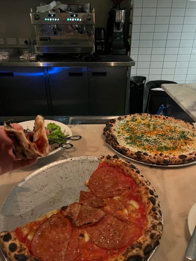 kObaYashi highly recommends the clam pizza at Bella Brutta for its unique minced clam and sour garlic flavor, reminiscent of non-spicy tom yum.