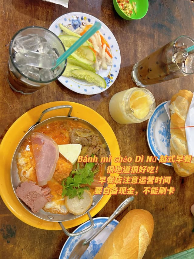 Eggs sizzling on an iron plate with ham, bacon, and fish cakes—it's calories and happiness maxed out. Add a Vietnamese iced coffee to inject some soul!