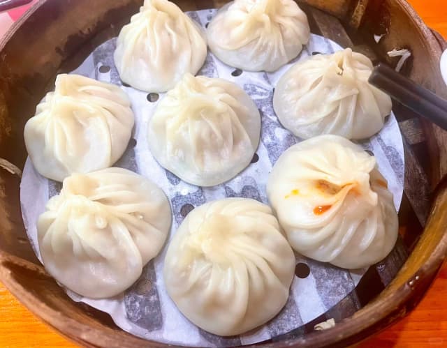 These xiaolongbao are exquisite, with delicate pleats. Take a bite, and the firm, juicy meat filling bursts with an incredible aroma.