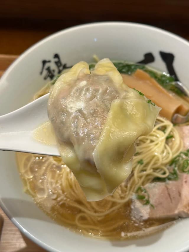 This isn't your typical ramen broth; it's a French-style consommé crafted from chicken, duck, kombu, and Italian prosciutto.