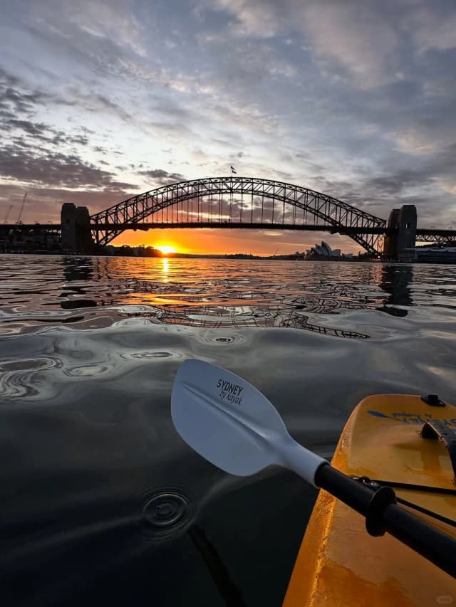 Professional Mandarin guides lead kayak tours to look up at the Sydney Opera House from sea level.