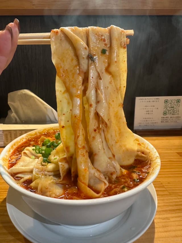 Known as 'Ittanmen,' these are super-wide noodles resembling a bolt of cloth, with a smooth, chewy texture that makes the soup cling to every bite.